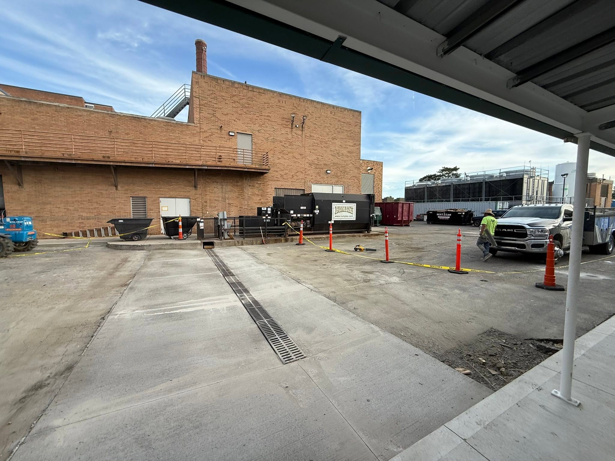 The same loading dock with a finished concrete service drive and trench drain